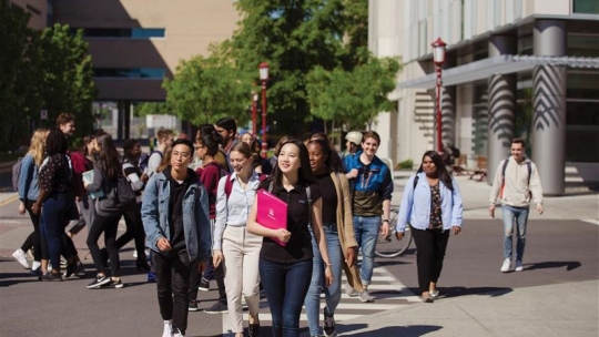 Diverse group of students walking on campus